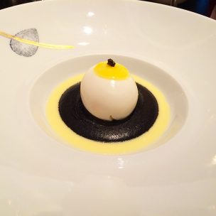 Soft boiled egg on a black truffle coulis and young Comte cheese cream