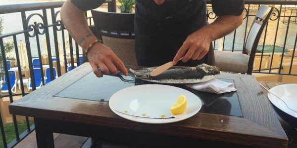 Seabass cooked in salt and filleted at the table