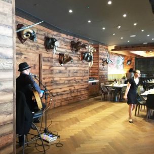 Guitarist playing in the corner of the room